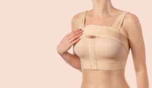 Woman wearing compression bra for recovery after breast reduction