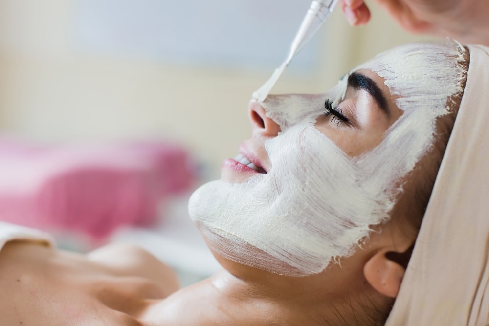 Woman getting chemical peel treatment in a medical spa setting