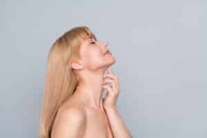 Woman with smooth, defined neck after lower face lift.