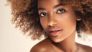 Woman with refined facial features and smooth skin following rhinoplasty