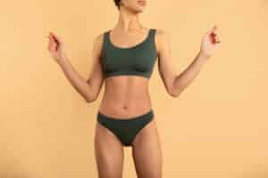 Woman with toned abdomen after body contouring procedure.