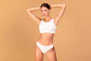 Woman showing a toned midsection, representing skin tightening and body contouring after weight loss with Morpheus8.